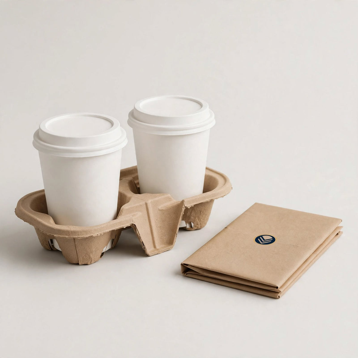 Kraft pulp two-cup carrier holding two plain white cups, folded four-cup carrier beside it โ custom cup carrier packaging Dubai