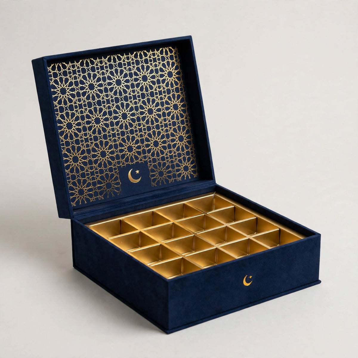 Navy Ramadan Eid gift box open with gold foil geometric lattice lid and compartment tray โ custom Eid gift boxes Dubai