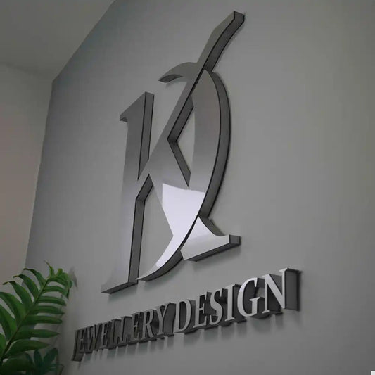 Brushed metal and acrylic wall sign lettering on a dark wall — acrylic sign Dubai