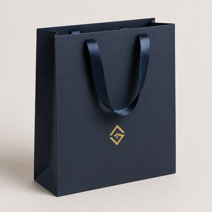 Navy boutique retail bag with gold logo and ribbon handles — ALEF UAE