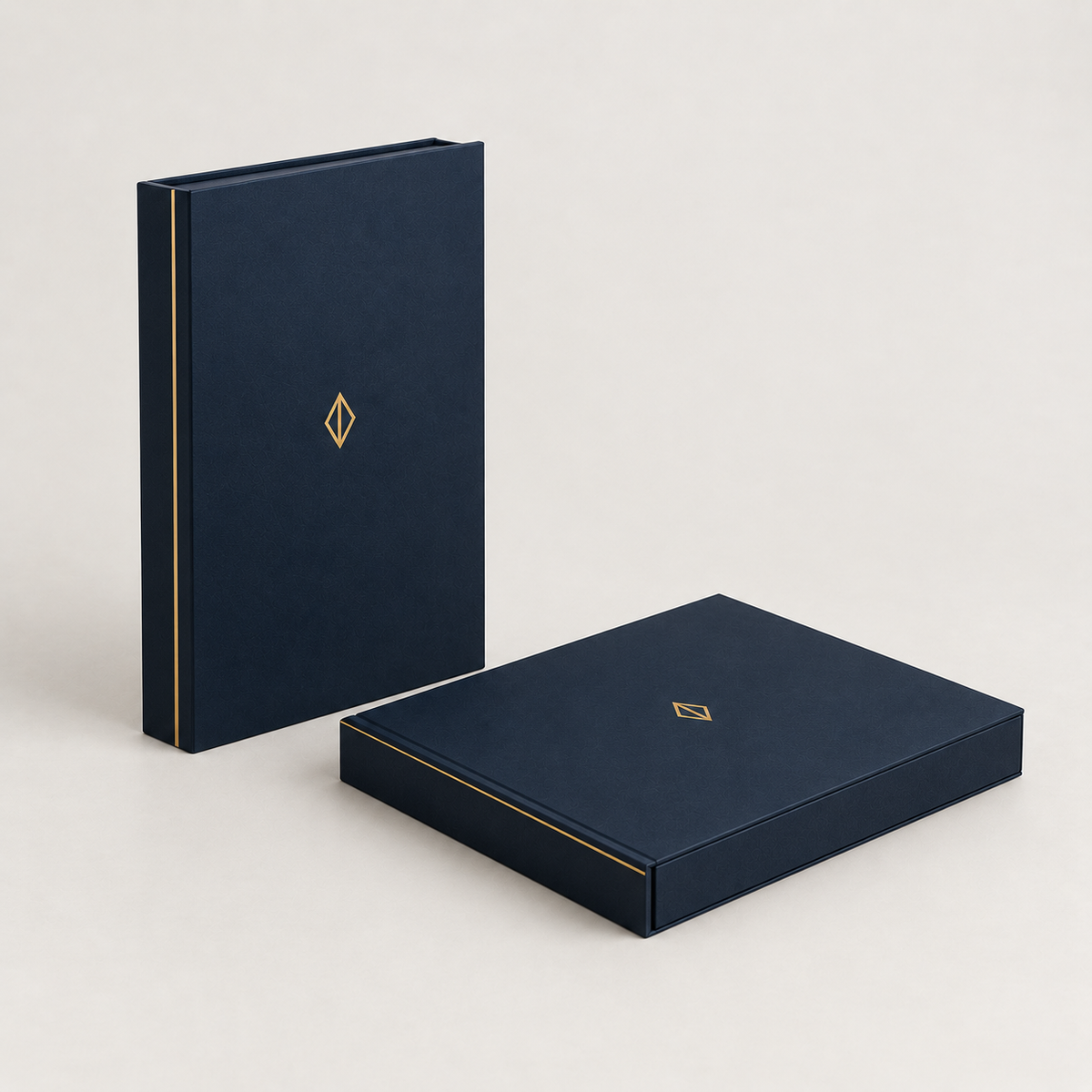 Navy book-style magnetic boxes closed, one standing and one flat, gold foil spine — custom magnetic gift boxes Dubai