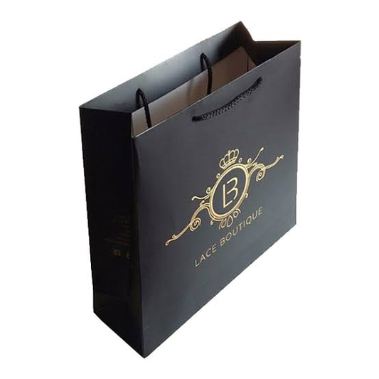 Black luxury paper bag with gold foil crest and rope handles — custom retail bags Dubai