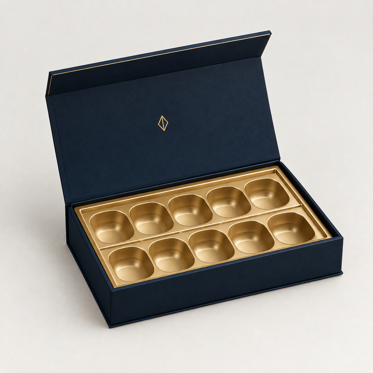 Navy magnetic chocolate gift box open with gold vacuum-formed tray — custom chocolate gift boxes Dubai