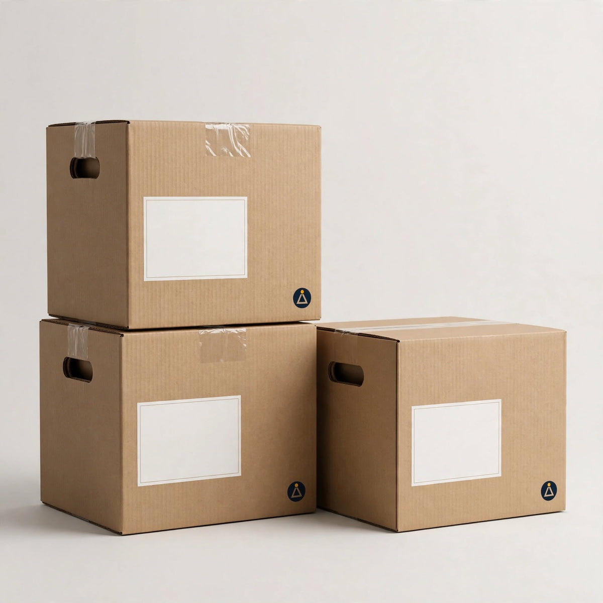 Stacked brown corrugated moving boxes with hand-holes and blank white label panels — custom moving boxes Dubai