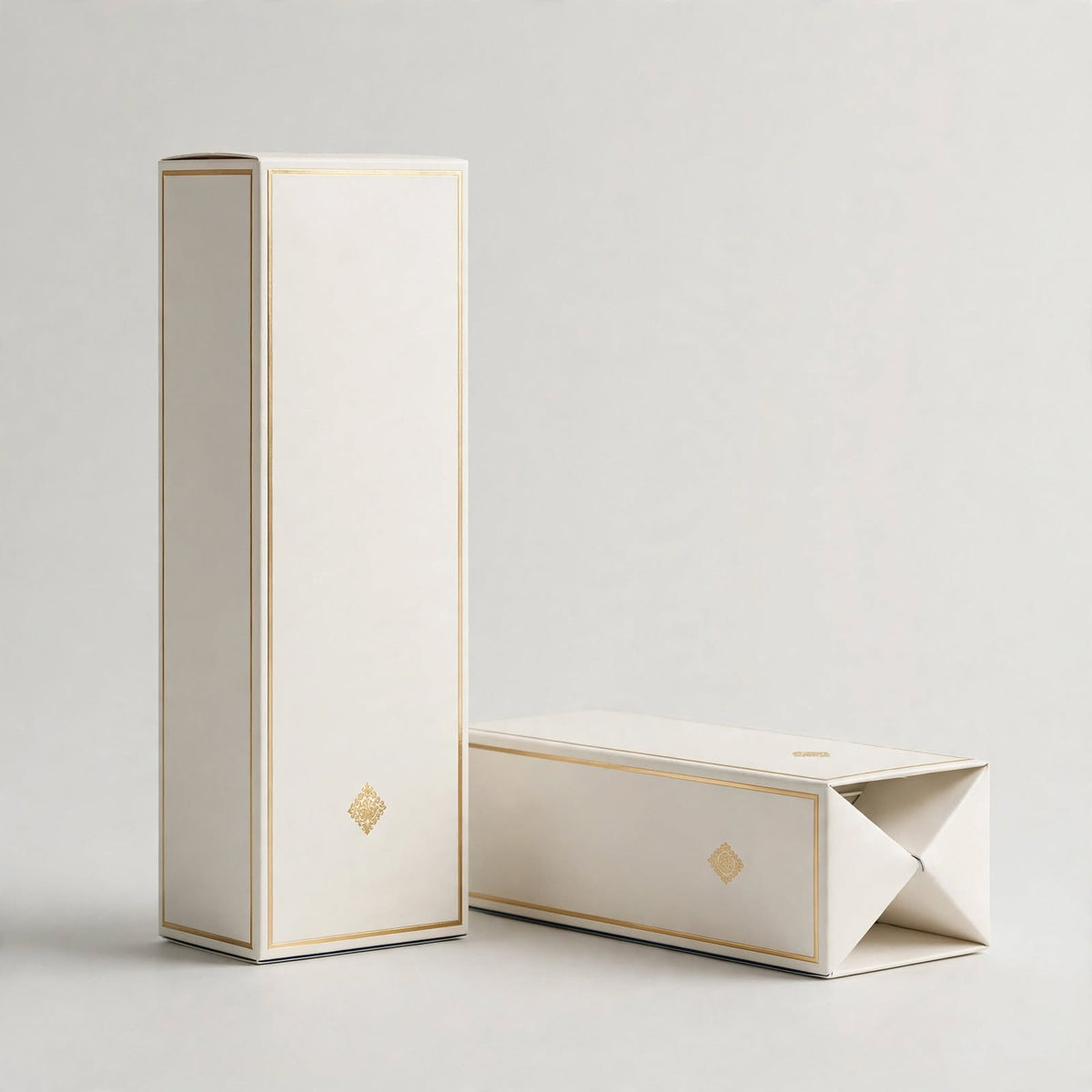 Ivory soft-touch perfume folding cartons with gold foil border, standing and flat — custom perfume cartons Dubai