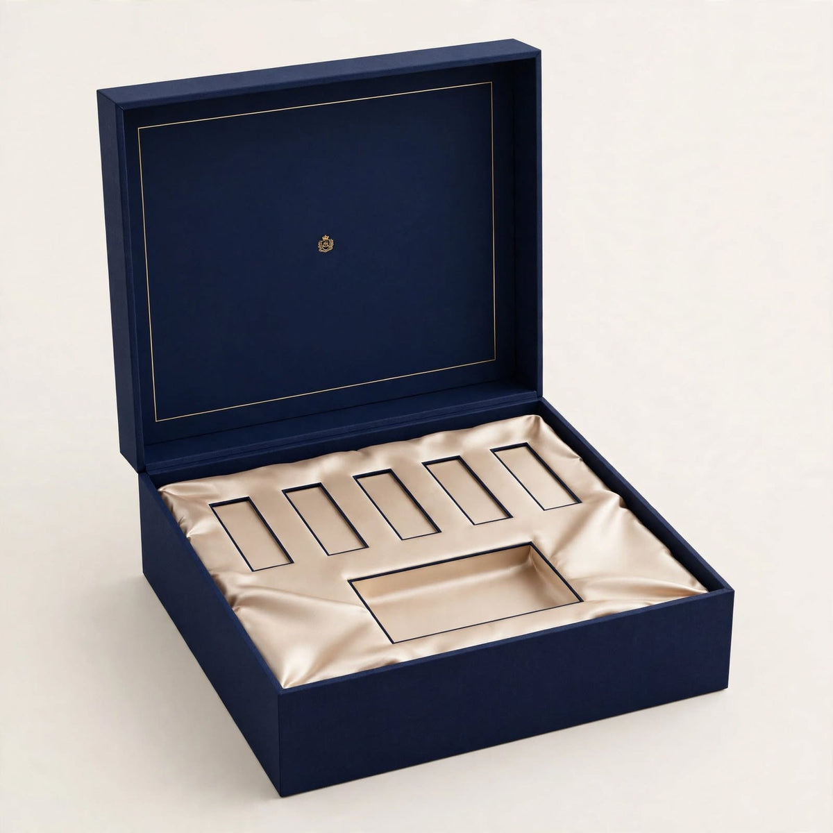 Navy rigid perfume gift set box open with champagne satin insert for vials and bottle — custom perfume packaging Dubai