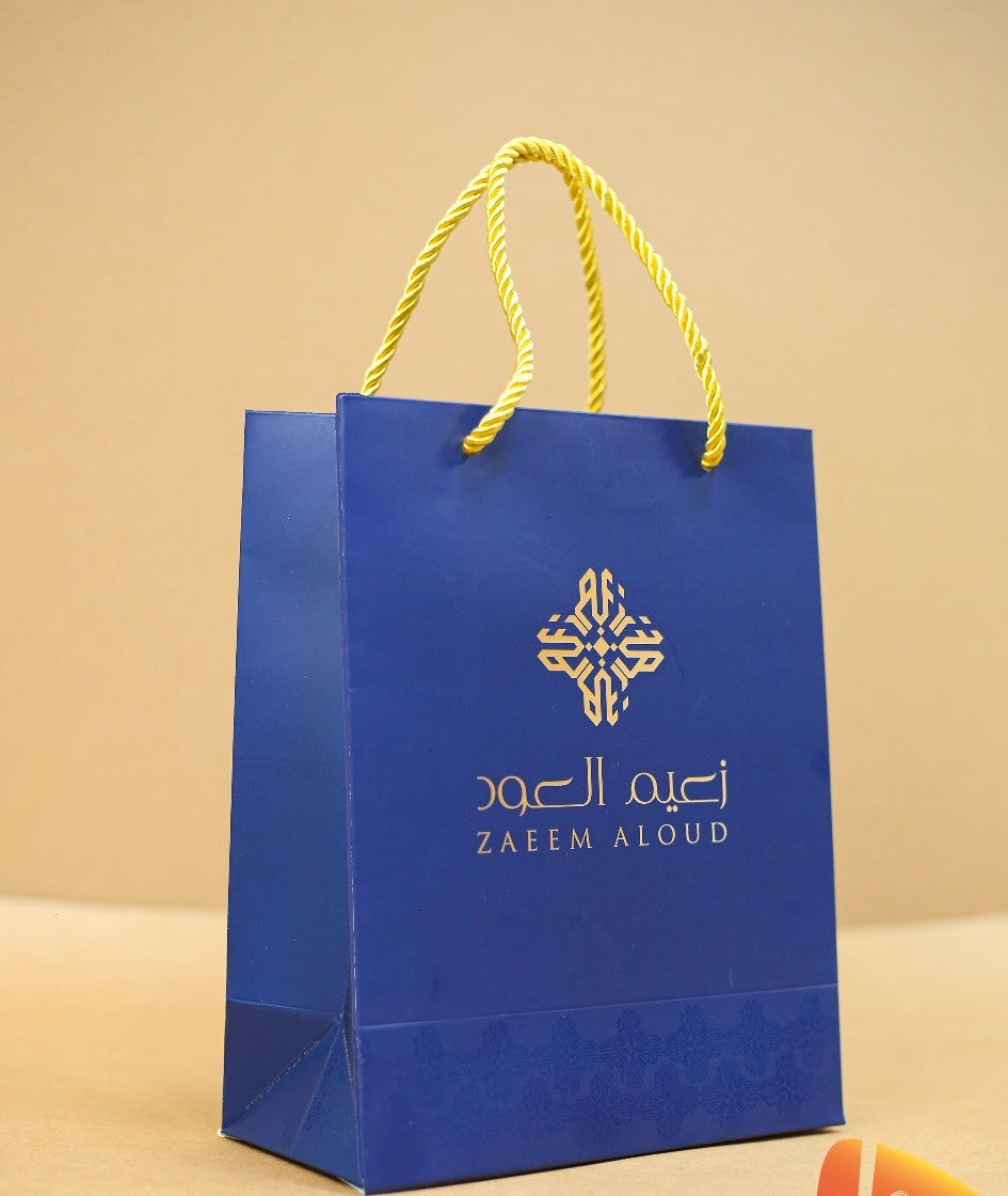 Royal blue printed gift bag with gold foil emblem and rope handles — custom gift bags Dubai