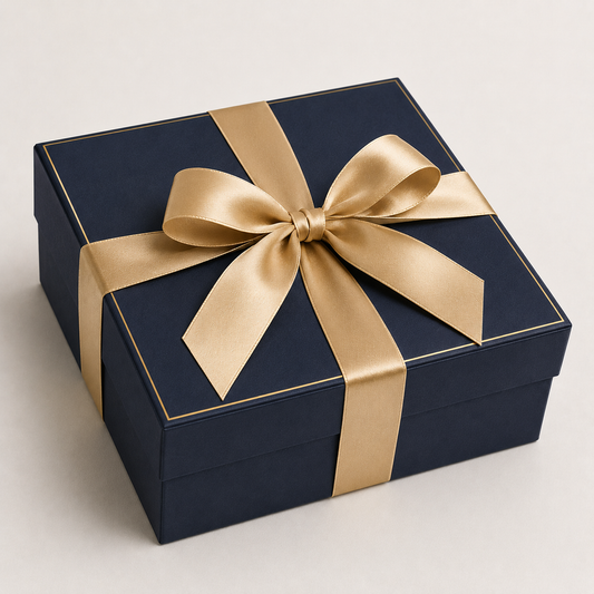 Custom navy rigid gift box with gold keyline and satin ribbon bow closure — ALEF UAE
