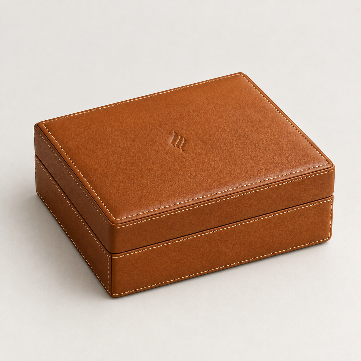 Cognac leather gift box with contrast saddle stitching, closed — custom leather gift boxes Dubai